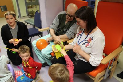 children and elderly patients enjoying a seaside party