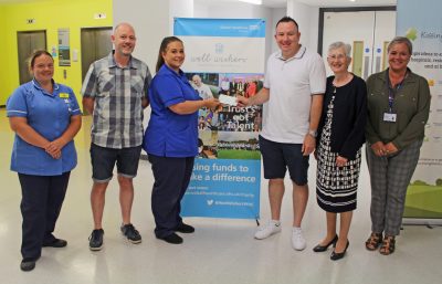 Handing over the cheque to staff from the chemotherapy unit