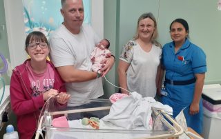 Hollie Kendall with her mum, dad and baby sister Chloe