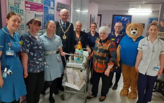 The Mayor and Mayoress with the fairground cake on the ward