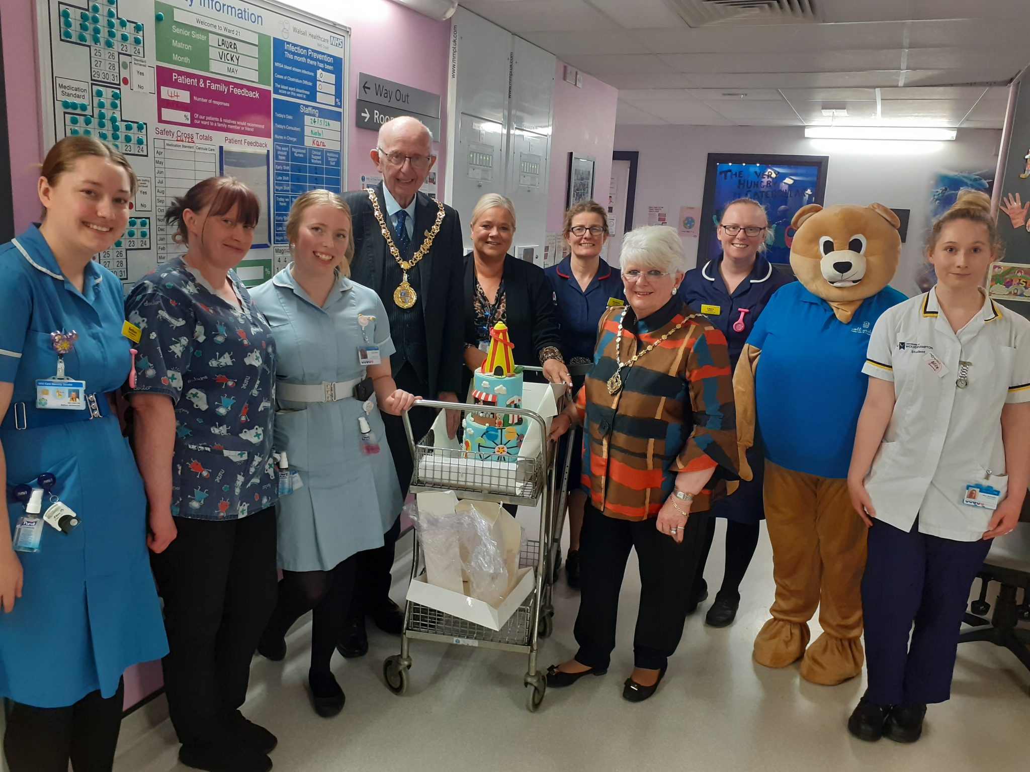 The Mayor and Mayoress with the fairground cake on the ward