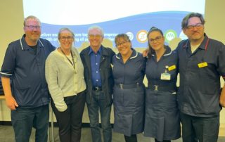 Tony Christie, centre, with the team